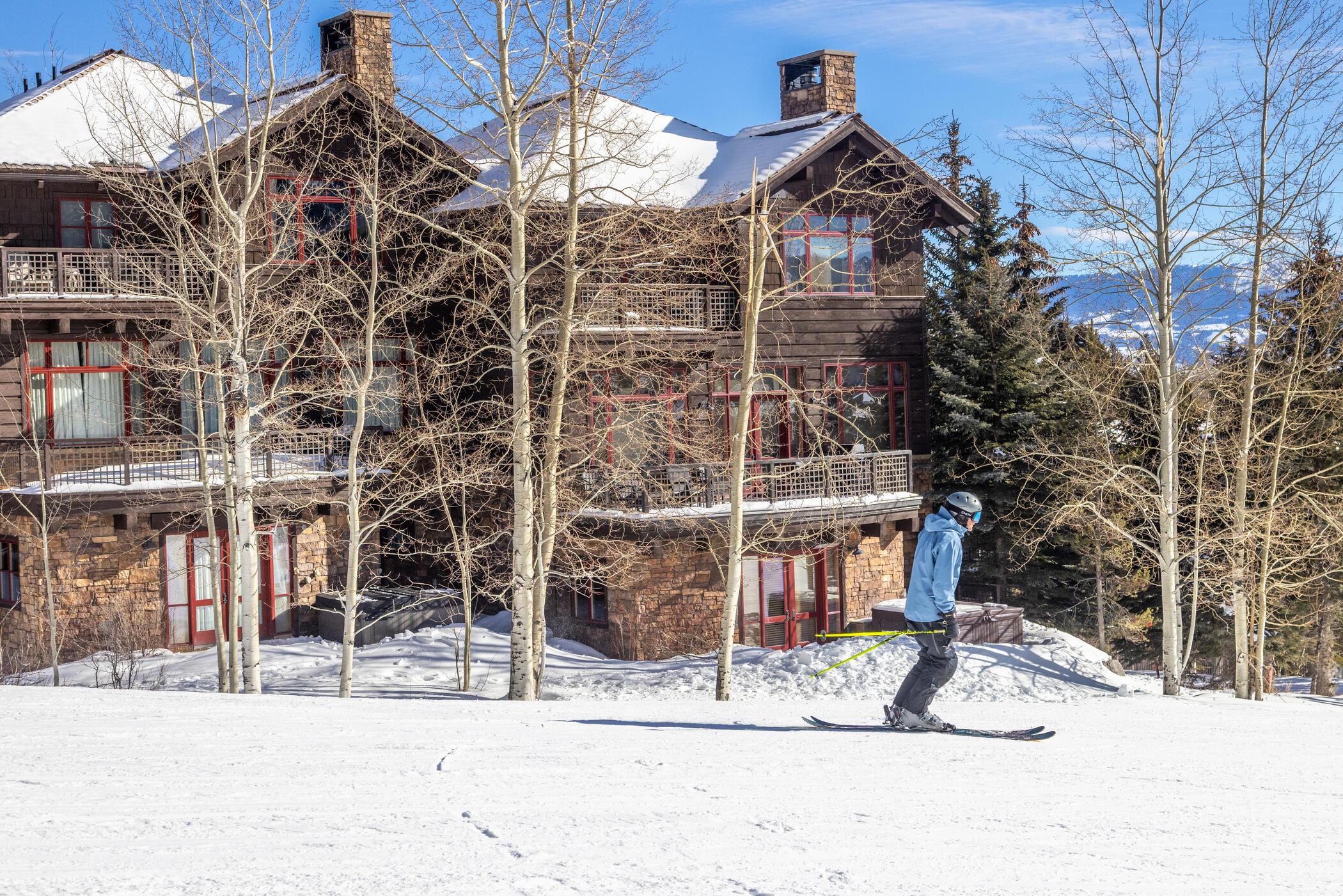 Skier skiing past slopeside cabing