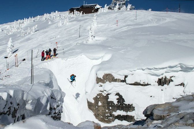 Skier drops into corbets