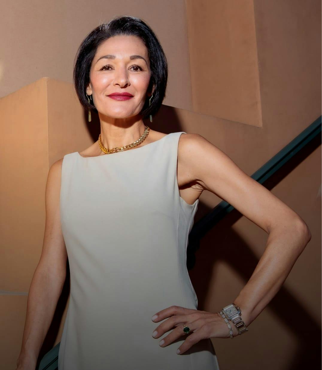 Dr. Salma Aziz, a Top Podiatrist in Newport Beach, Posing And Smiling In White Dress.