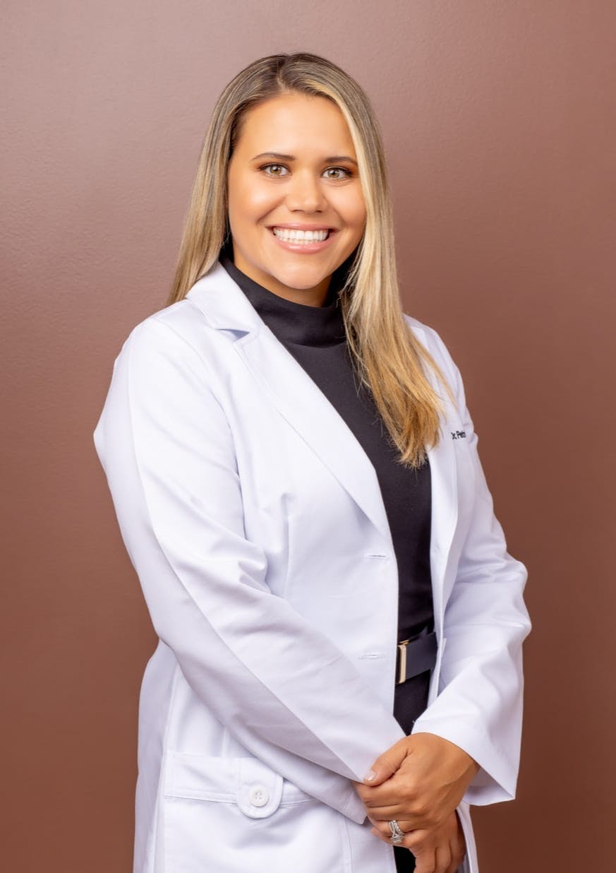 Dr. Petrina Yokay, a top Podiatrist in Newport Beach, Smiling And Wearing White Doctor's Coat.