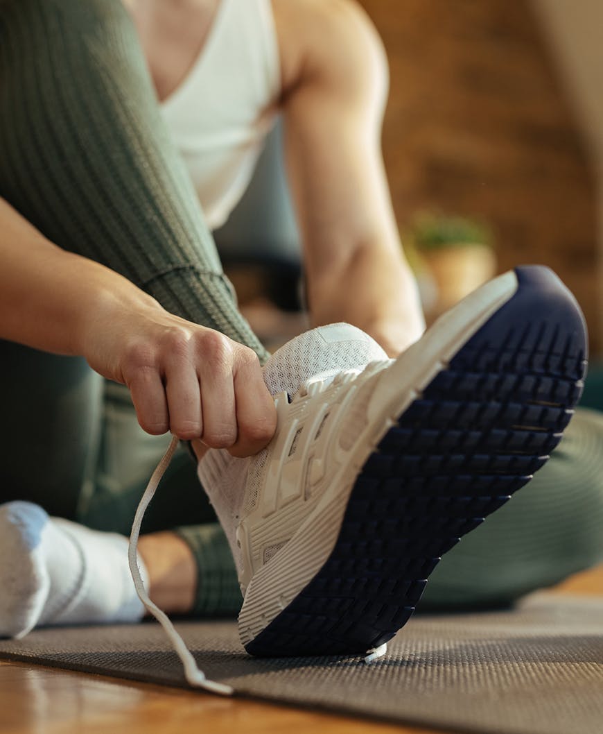 Women Putting On Running Sneakers After Hammertoe Correction In Rancho Santa Margarita
