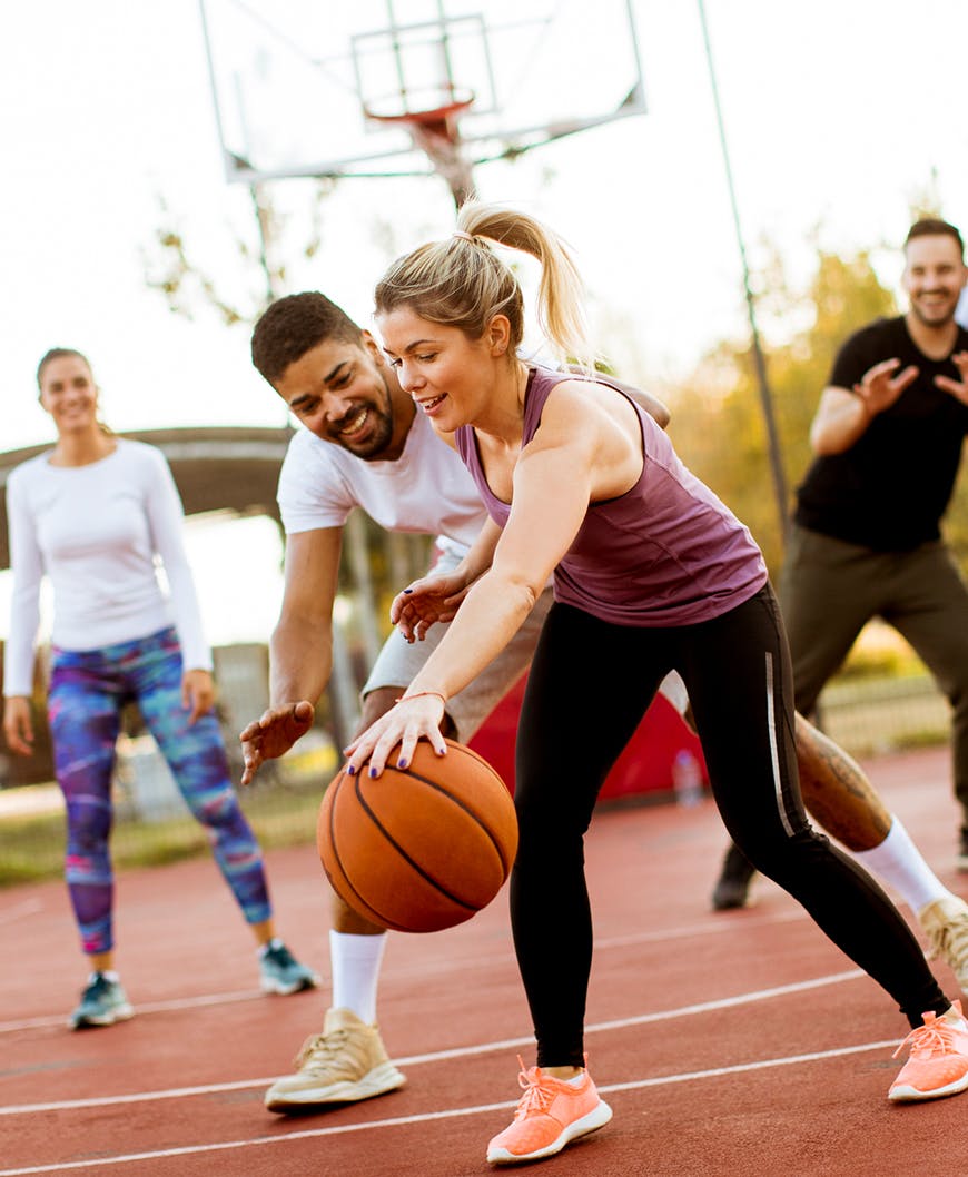 Two Women And Men Playing Basketball After Receiving Sports Orthotics In Newport Beach.