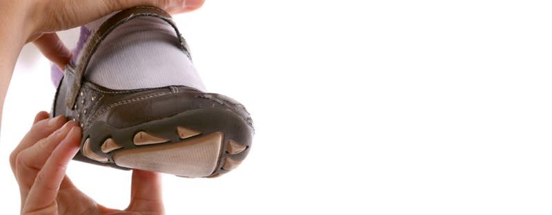 a close up of a child's foot wearing a sock and shoe