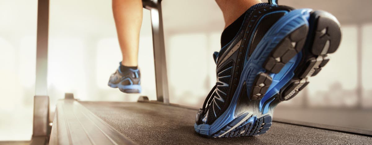 and close up image of someone's feet as they're running on a treadmill