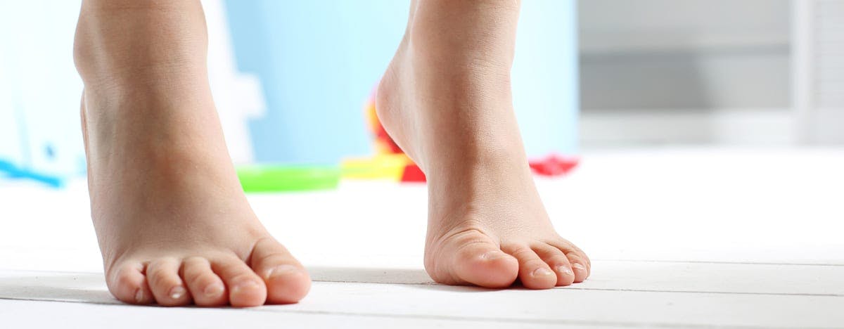 a young person's bare feet standing on their tippy toes