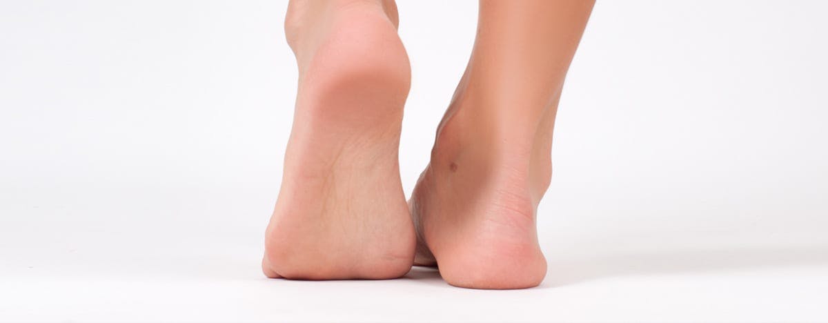 a close look at the back of someone's foot with their heel raised
