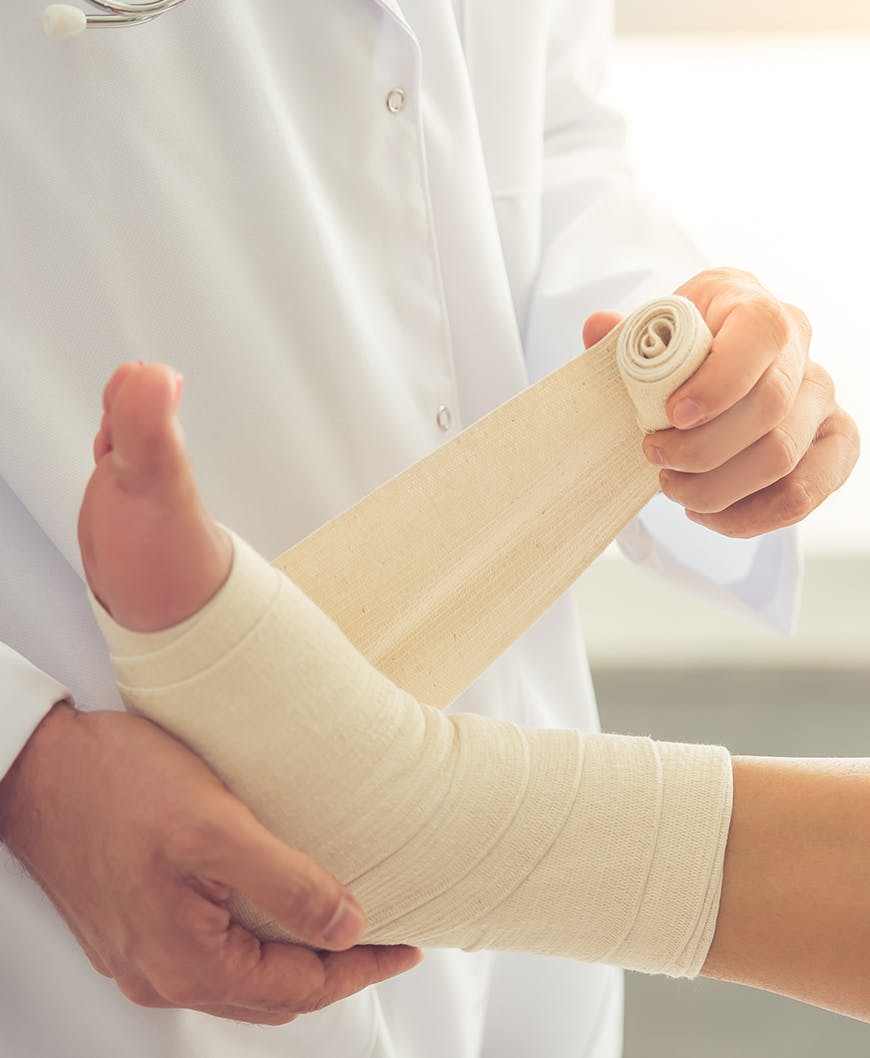 Doctor Bandaging Patients Foot After Foot Surgery In Newport Beach.