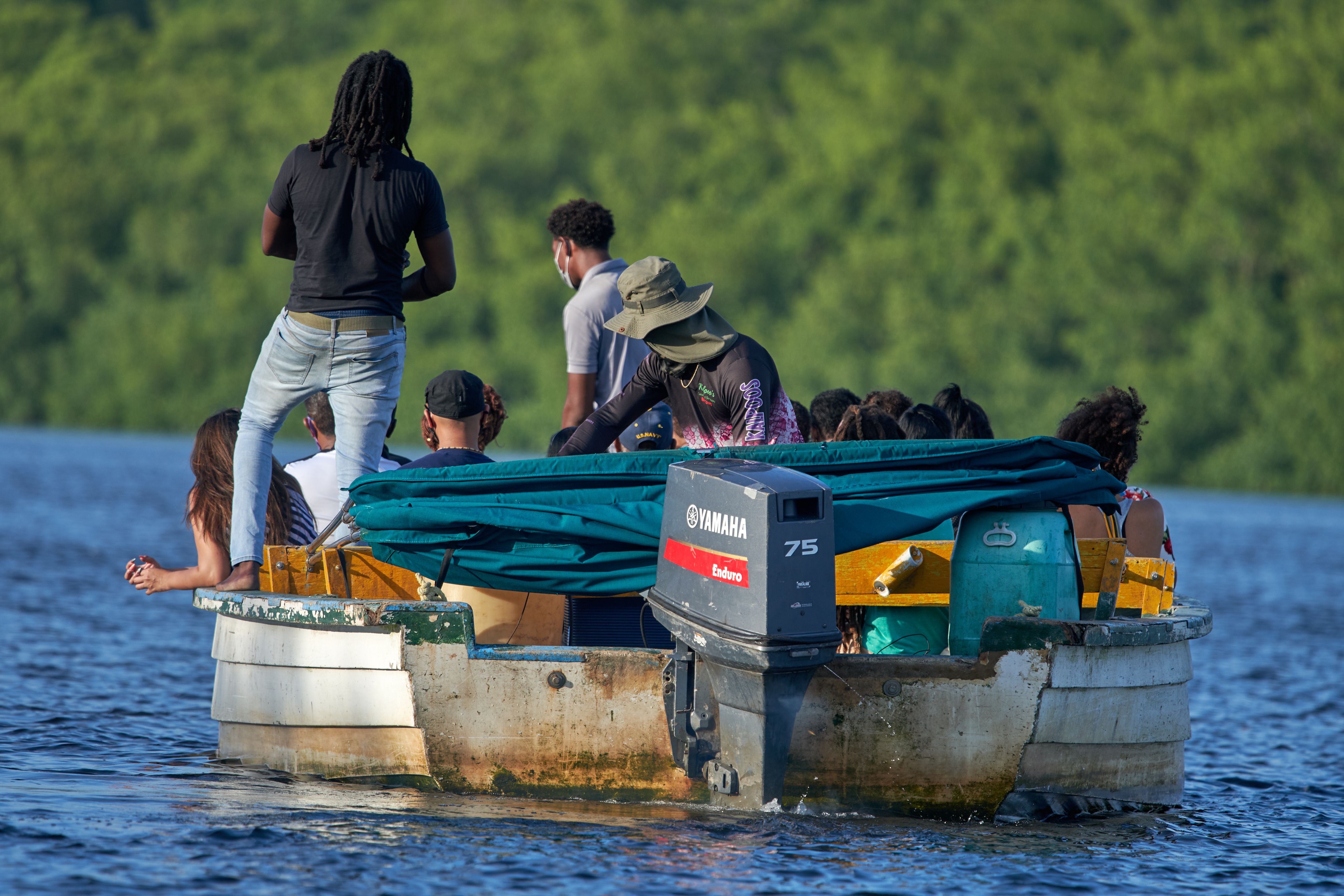 A group of people on a small fishing boat.