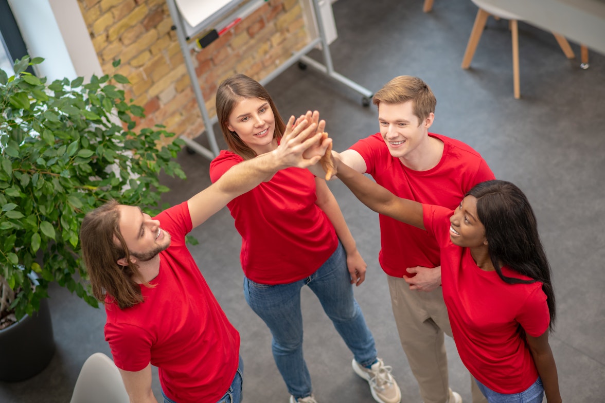 Employees in team building with red shirts