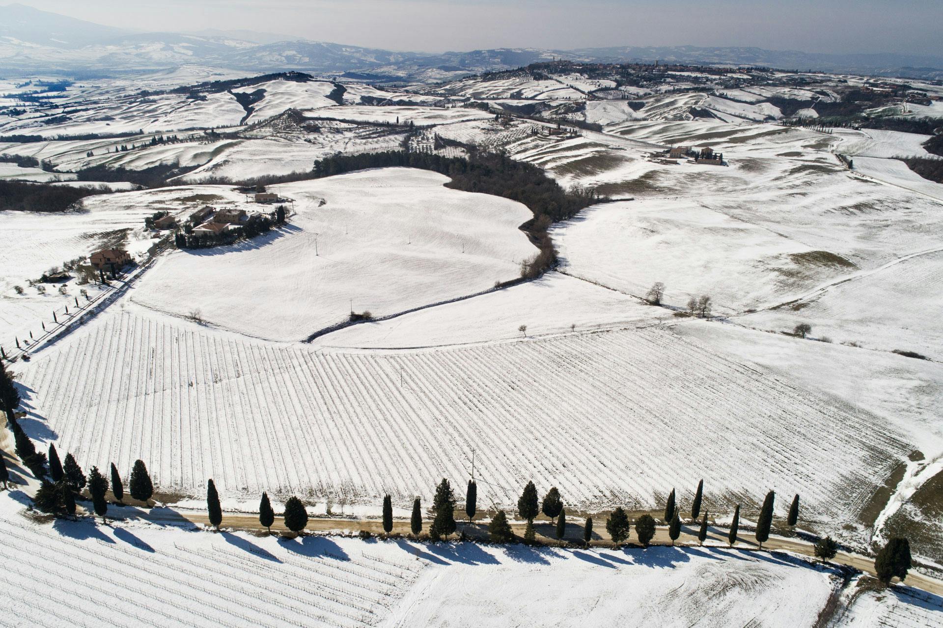 Aerial view by drone in winter with some snow in the Val d'Orcia