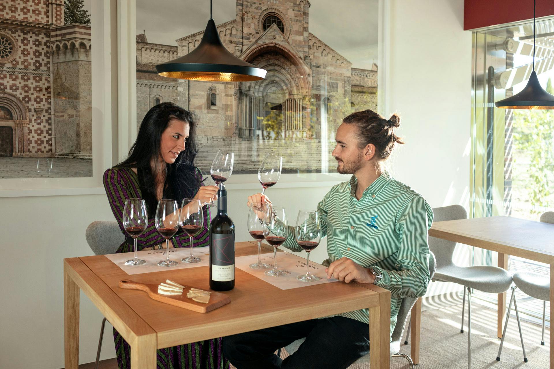A couple is tasting the wines of Fabbrica with some cheese