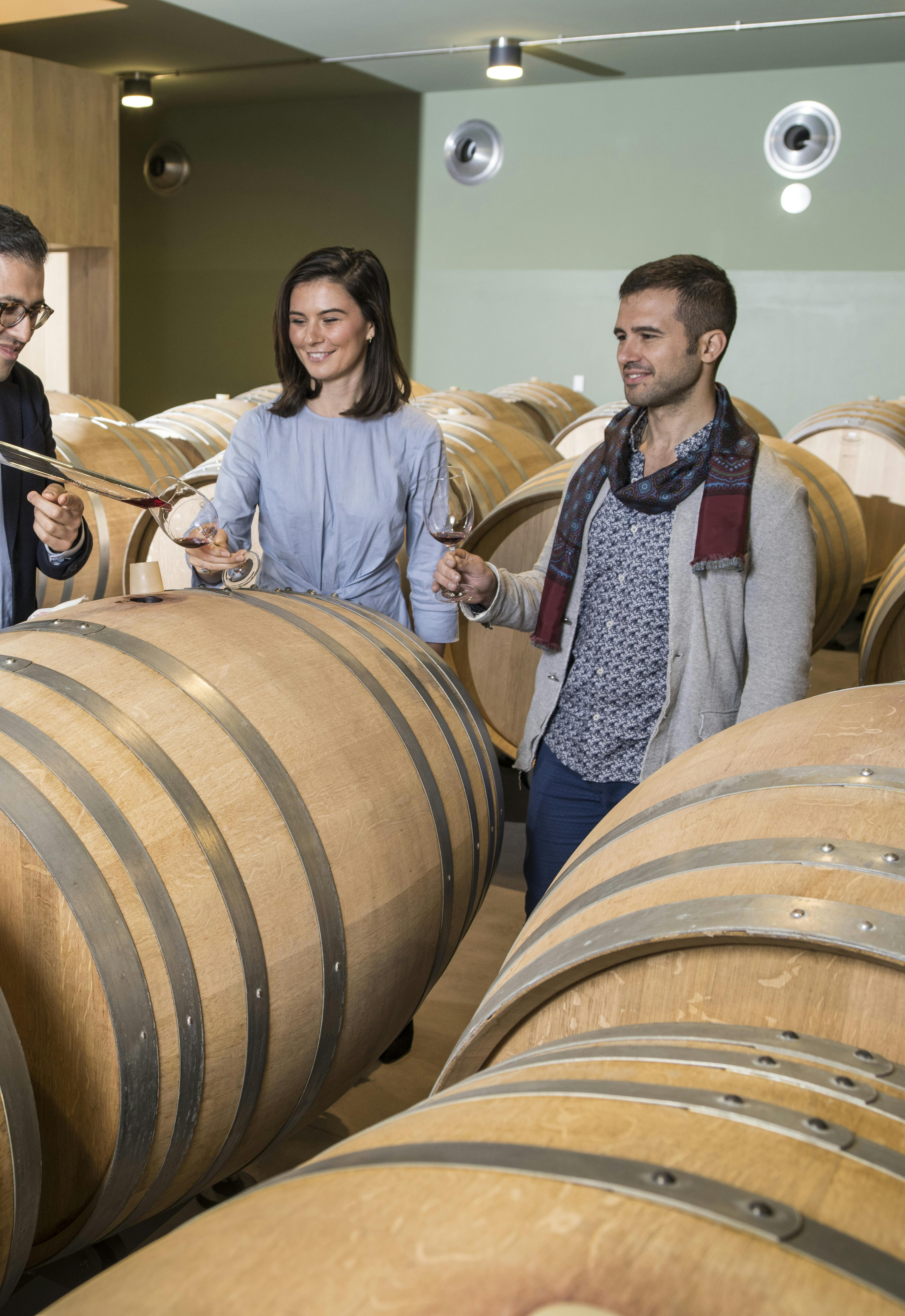 Hospitality-Tasting wine from the barrel for the VIP experience tour A couple is taasting some wine directly from the barrel during the VIP experience tour at Fabbrica