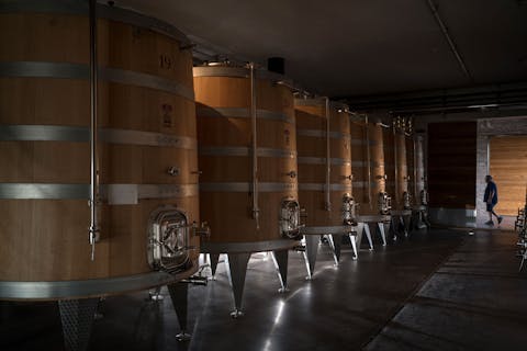 View on large conical wooden casks in the winery of Fabbrica Pienza
