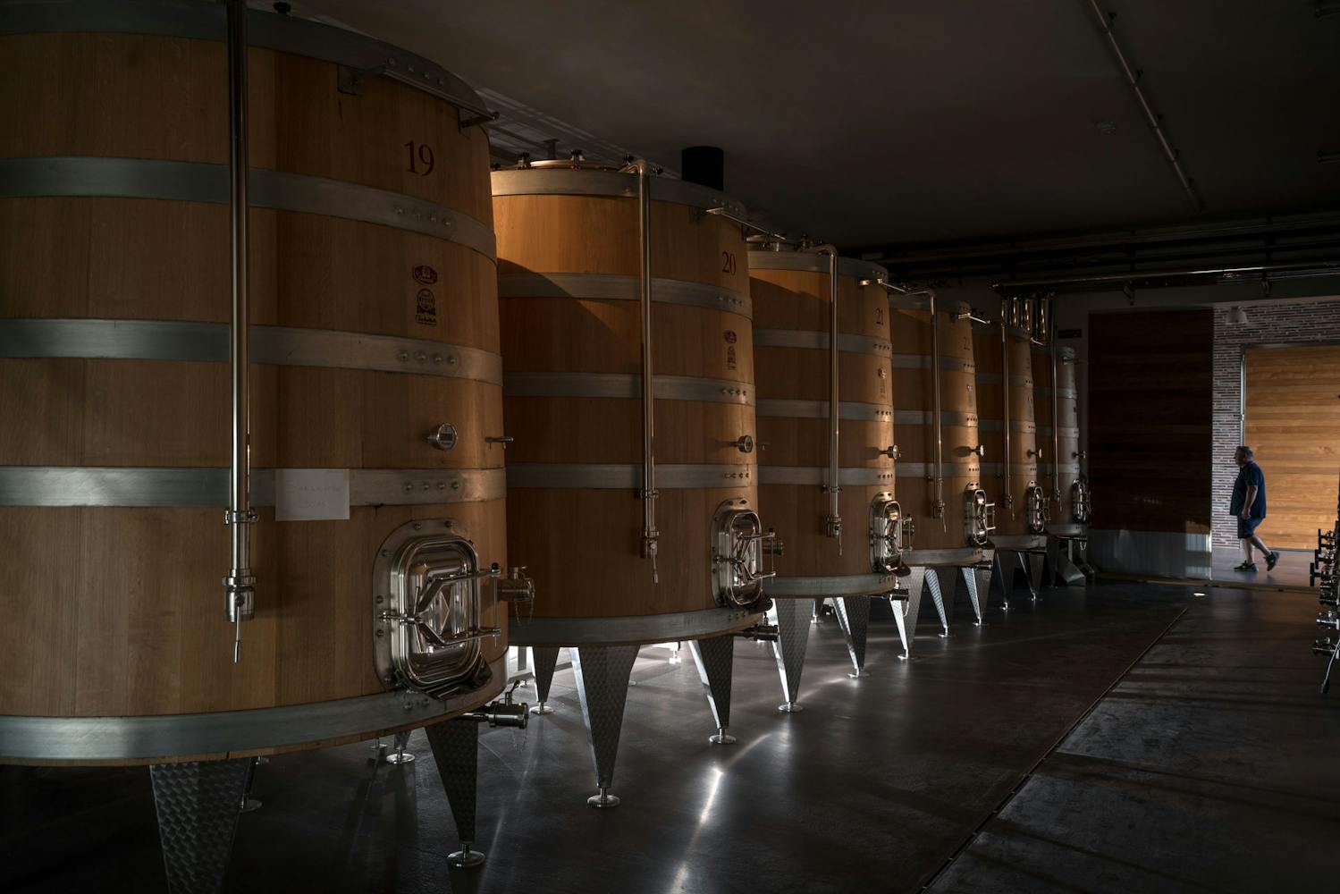 View on large conical wooden casks in the winery of Fabbrica Pienza