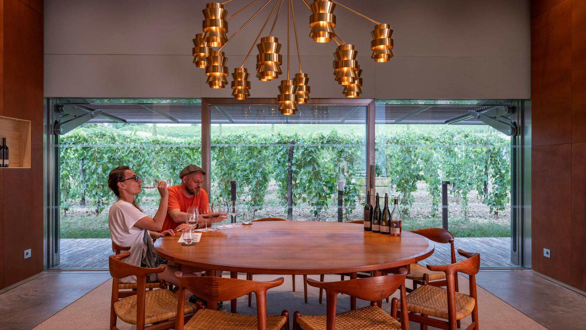 Tasting room A couple is tasting Fabbrica wines around a big wooden table in the main tasting room