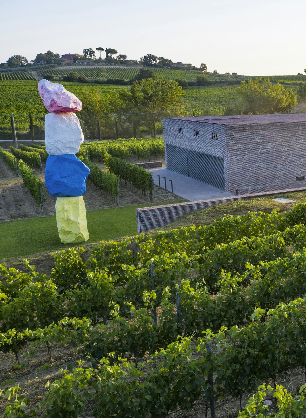 Fabbrica winery with Ugo Rondinone sculpture View on Fabbrica winery with colourful sculpture of Ugo Rondinone and vineyards