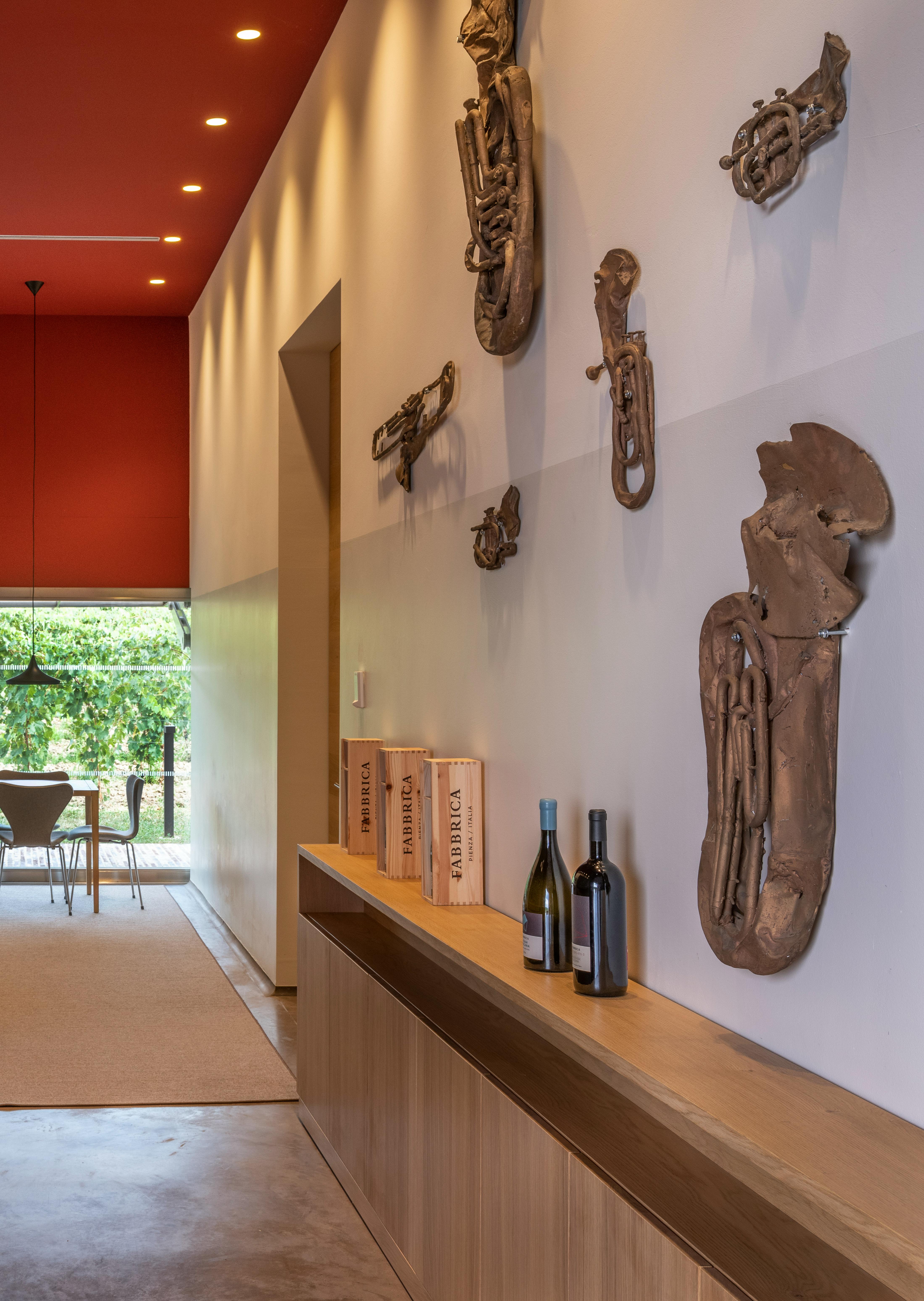 Tasting room with bar and sculptures by Valentin Carron