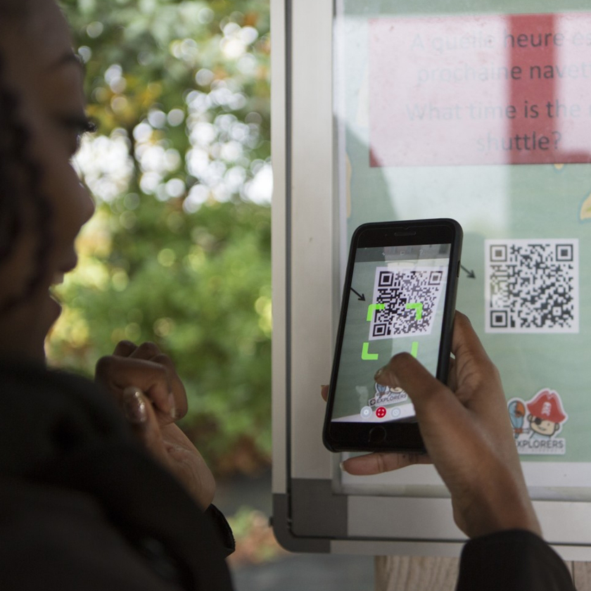 Passenger scanning a QR code with her phone