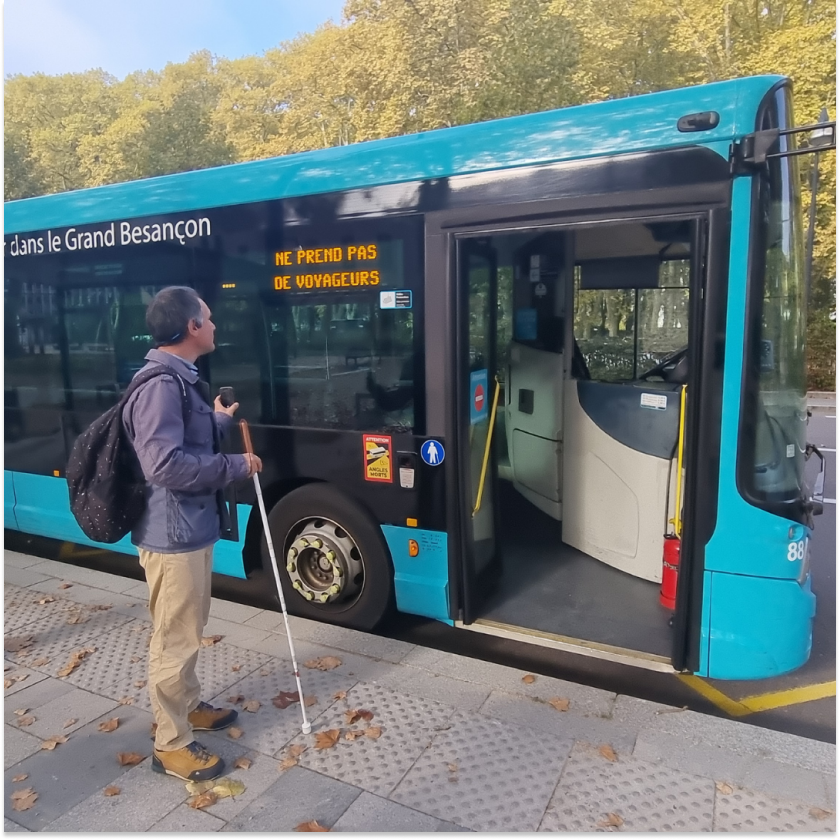 Visually impaired person using the Easymob application to locate a bus entrance
