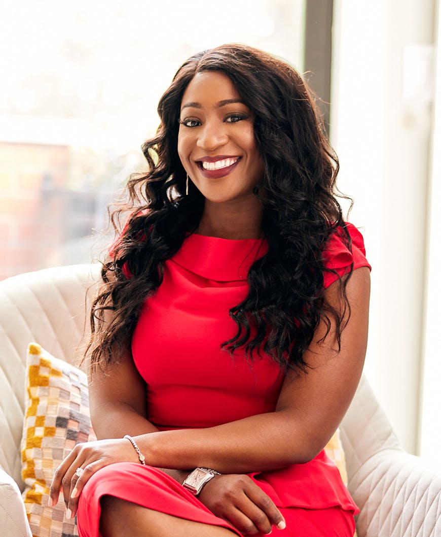 Dr Omotara smiling in a red dress