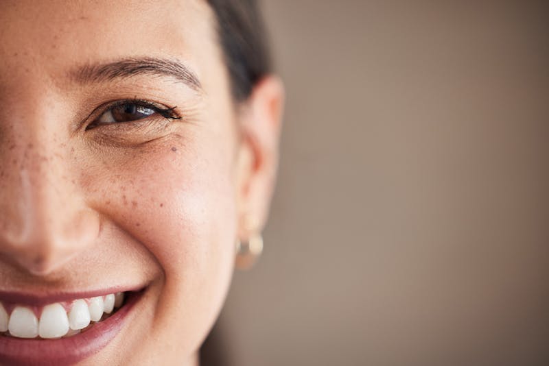 Face of beautiful mixed race woman smiling with white teeth