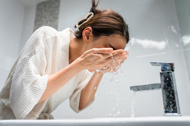woman washing her face