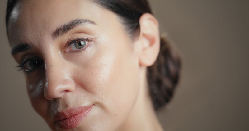 woman with dark hair in a low bun