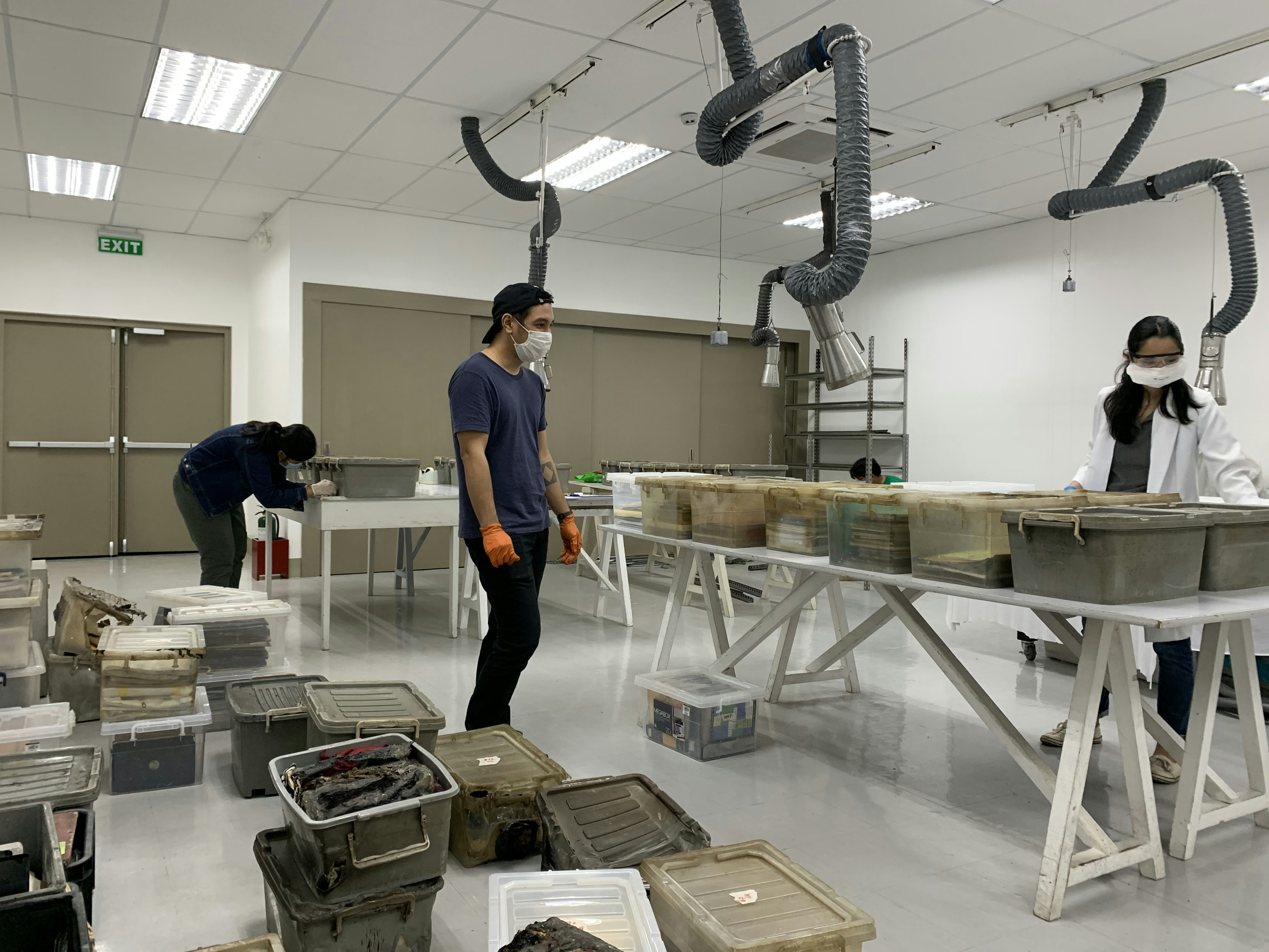 Volunteers cleaning and assessing archival materials. 