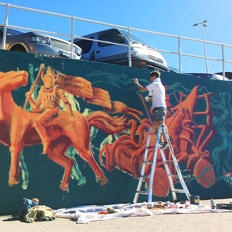 Rel painting a mural for the Bondi Beach Sea Wall in 2018