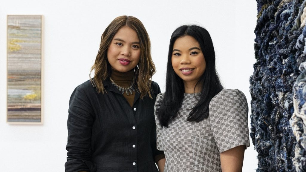 Photo of Lauren Hernandez and Kass Hernandez of Crossing Threads at 4A during the exhibition "Holding Patterns: Crossing Threads."