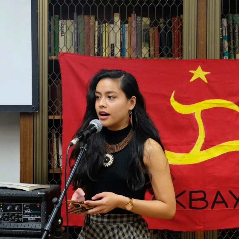 Eunice Andrada reads her poems at Anakbayan’s community fundraiser for the families of farmers murdered by the Philippine military, 2019; photo: Bryle Leaño