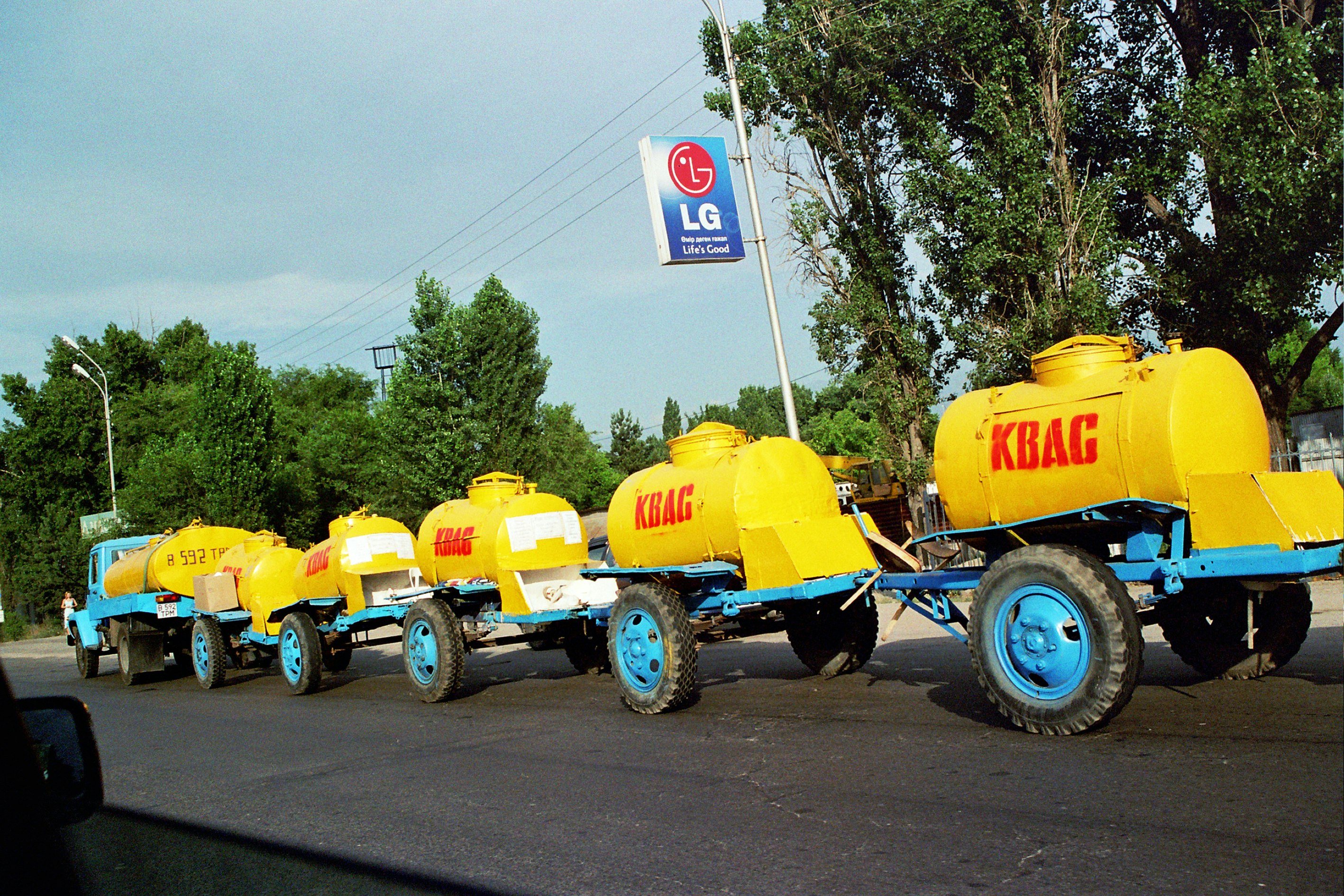 A line of connected yellow carts with the letters 'KBAG' in red writing. 