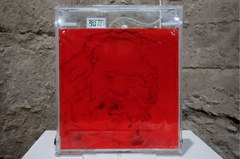 Red liquid in a clear plastic box.
