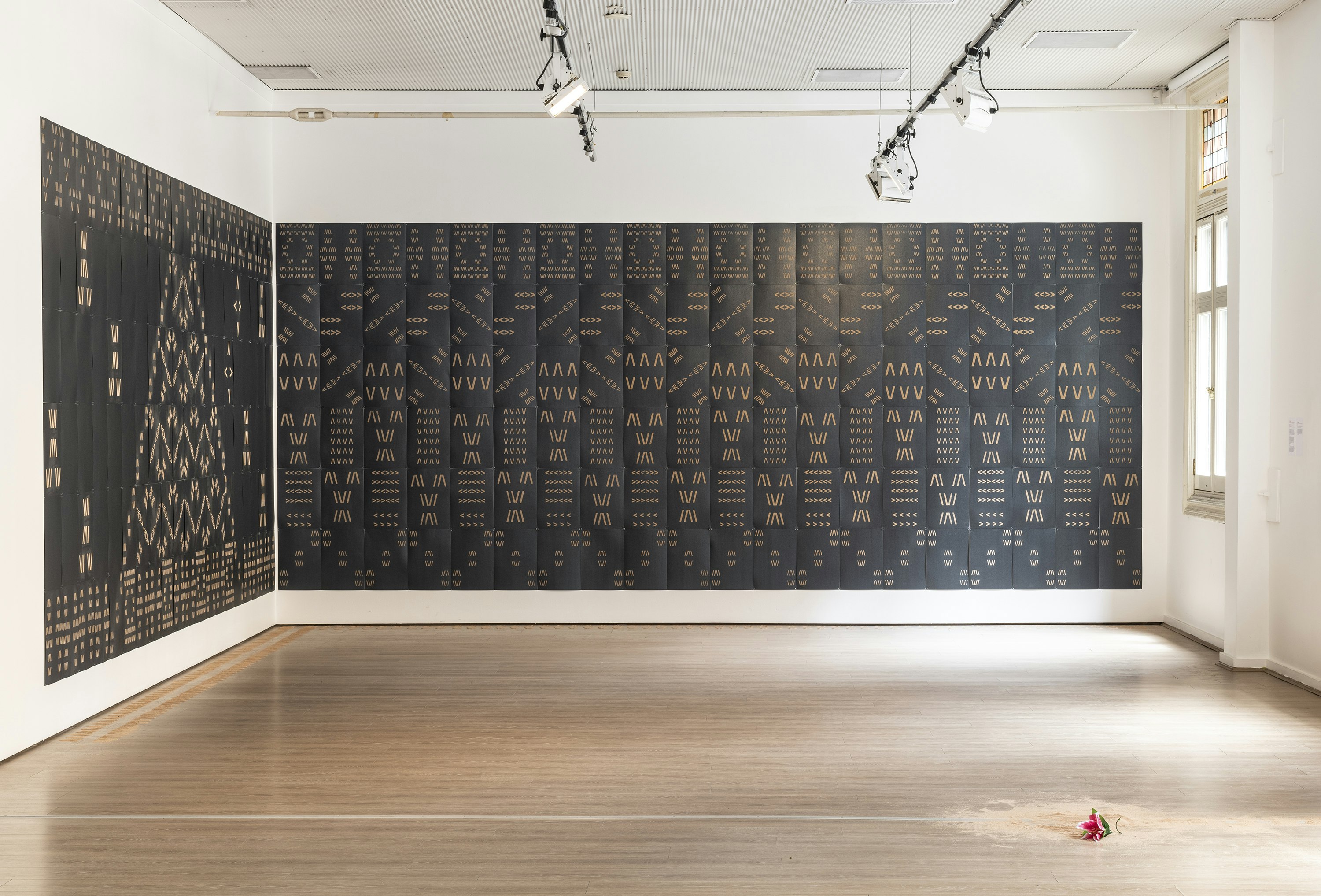Vaimaila Urale, Manamea ma Anivanuanua, 2020, installation view: black card and sand, 240 pieces across two walls, each wall installation measuring 5940x2520mm; commissioned by 4A Centre for Contemporary Asian Art for Wansolwara: One Salt Water; photo: Kai Wasikowski for 4A Centre for Contemporary Asian Art; courtesy the artist.