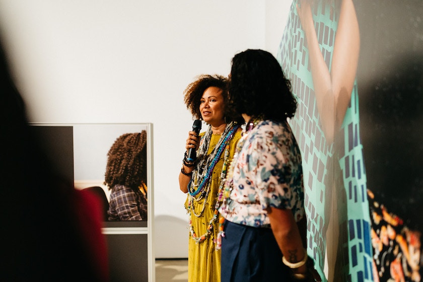 Lisa Hilli and Dr Léuli Eshrāghi speak in front of Sisterhood Lifeline, within The Commute at the Institute of Modern Art, Brisbane; image courtesy the Institute of Modern Art.