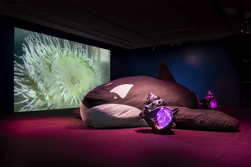 Front: Zadie Xa, Cellular Portal, 2019, polymer resin, acrylic spray paint, LED lights, dimensions variable, Granny, 2019, denim, and mixed fabrics, dimensions variable; photo: Kai Wasikowski for 4A Centre for Contemporary Asian Art; I am heart beating in the world: Diaspora Pavilion 2, Campbelltown Arts Centre; courtesy the artist.    Back: Zadie Xa, Child of Magohalmi and the Echoes of Creation, 2019, single channel HD video, stereo sound, 50min 21sec; commissioned by Art Night London 2019; photo: Kai Wasikowski for 4A Centre for Contemporary Asian Art; I am heart beating in the world: Diaspora Pavilion 2, Campbelltown Arts Centre; courtesy the artist.    Presented by 4A Centre for Contemporary Asian Art and International Curators Forum in partnership with Campbelltown Arts Centre.