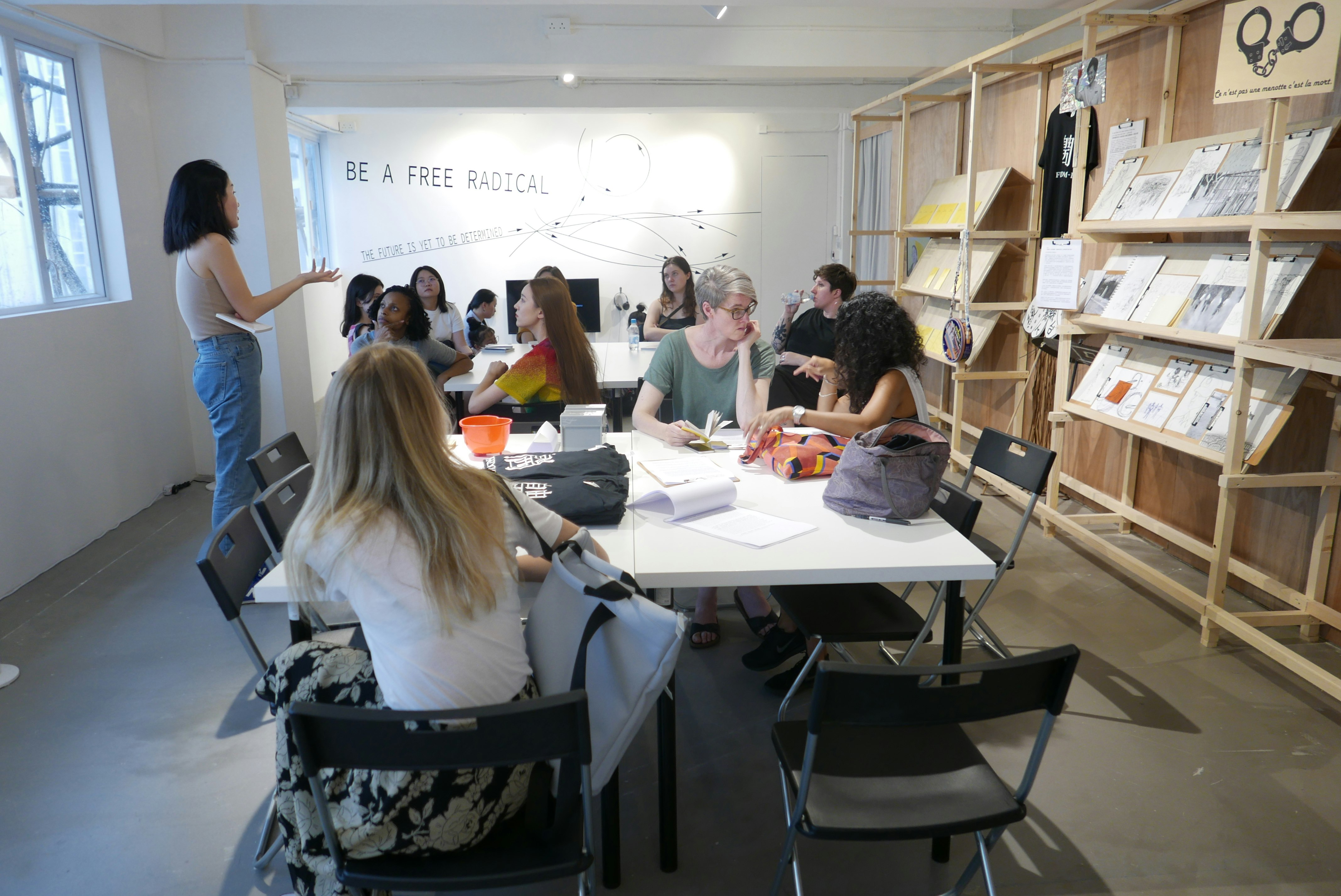 Curator and writer Freya Chou, talking with students from the University of Melbourne Advanced Art Fieldwork, Contemporary art in China intensive at Parasite, Hong Kong, July 2019. Photo: Claire Roberts.