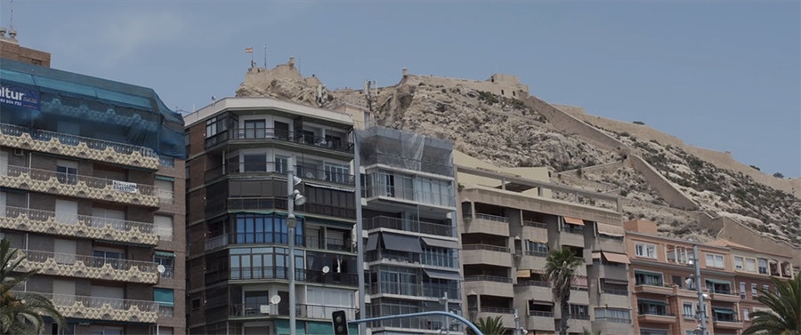 Still of apartment facades set into a hill in Lebanon.