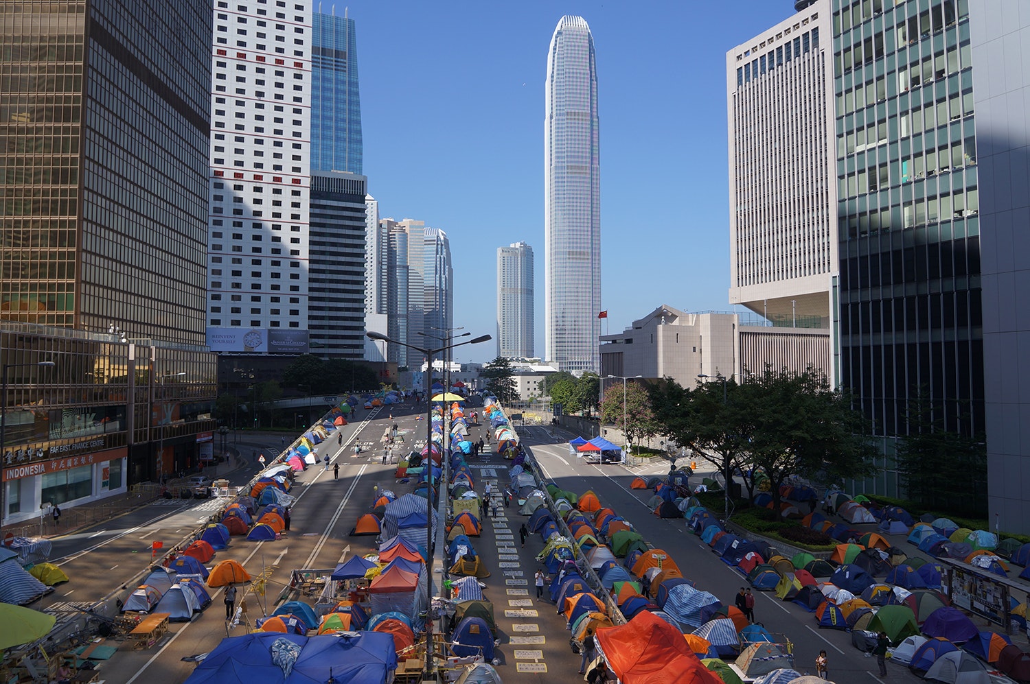 Two urban streets in Hong Kong lined with makeshift tents. 