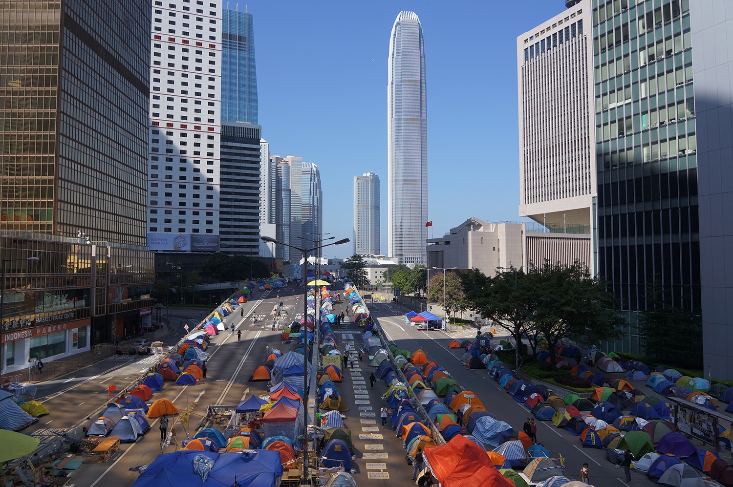 Two urban streets in Hong Kong lined with makeshift tents.