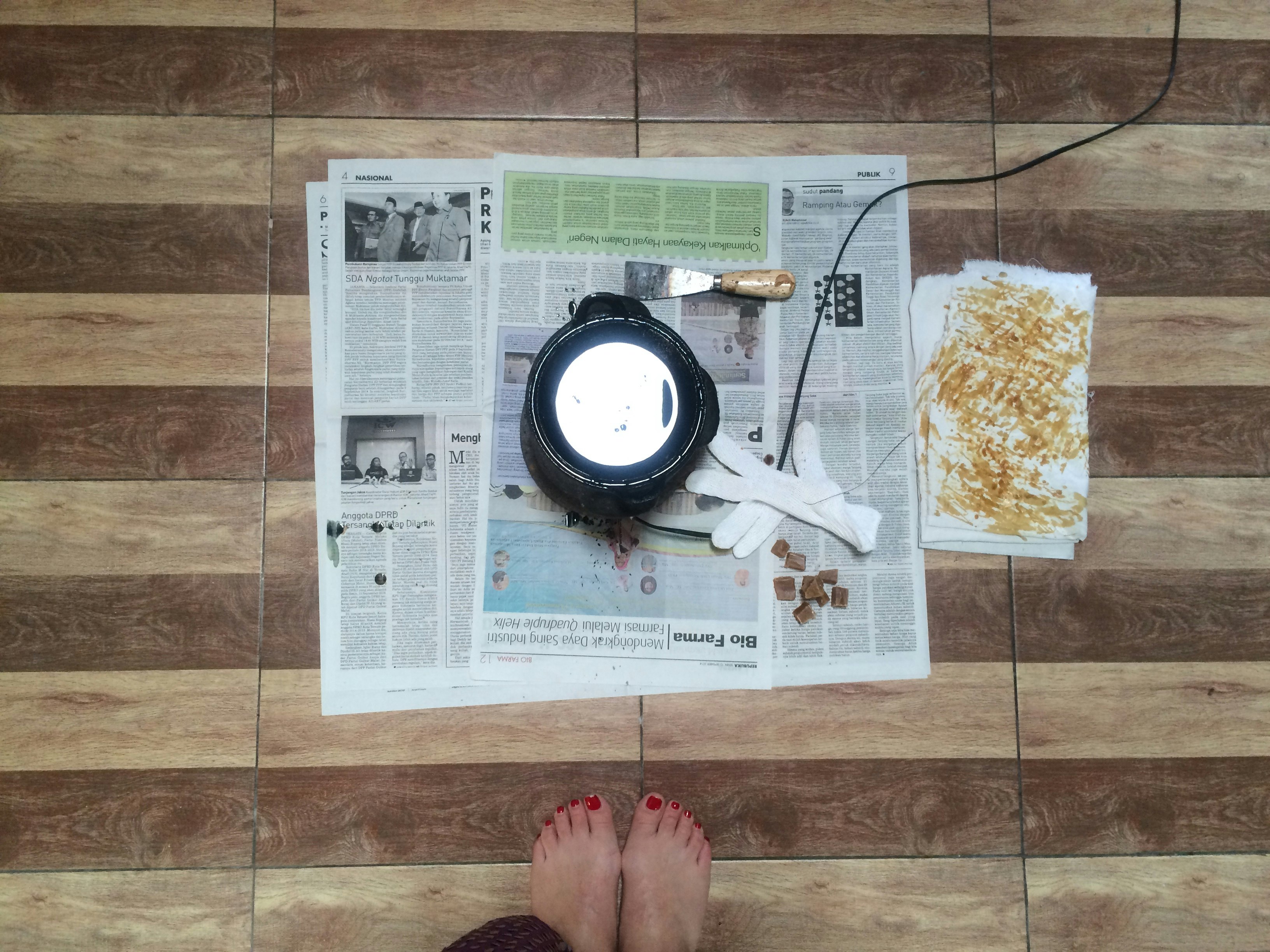 A bird's eye view of broadsheet newspapers laid on the ground.