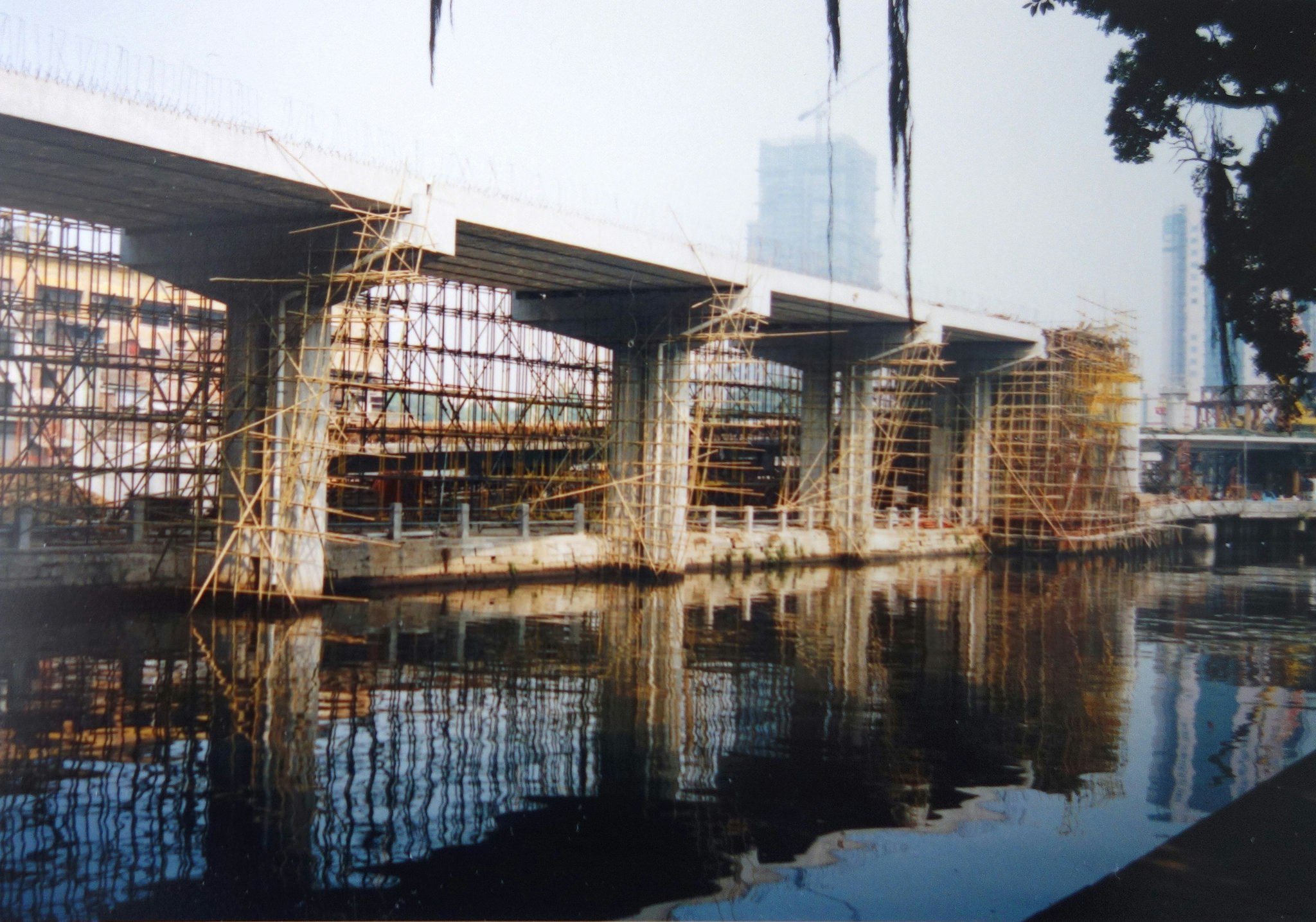 Scaffolding around a bridge over water.