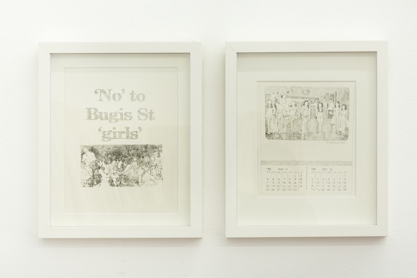 Two white framed artworks on a gallery wall; one with the words "'No' to Bugis St 'girls' and the other with a graphite print of a photograph over a graphite printed calendar