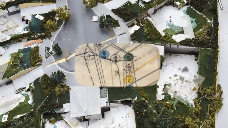 An aerial view of buildings in a cul-de-sac amidst greenery