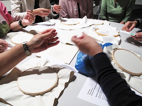Participants of Liyen Chong's workshop making embroideries with their own hair