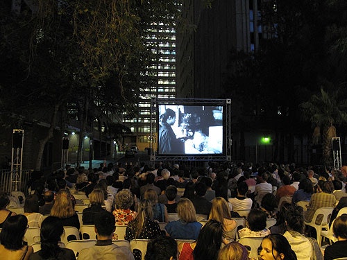 A seated audience watching a film during 4A Cinema Alley at night