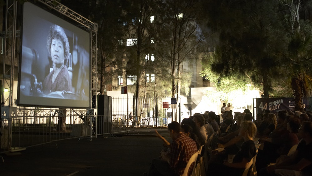 Seated audience watching a film during Cinema Alley 2011 at night