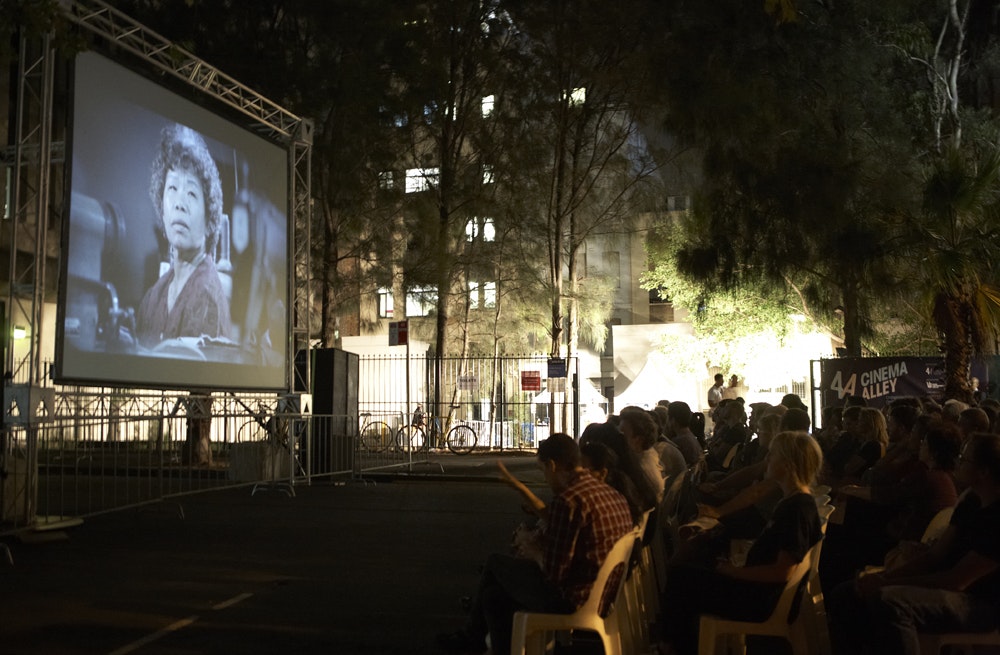 Seated audience watching a film during Cinema Alley 2011 at night