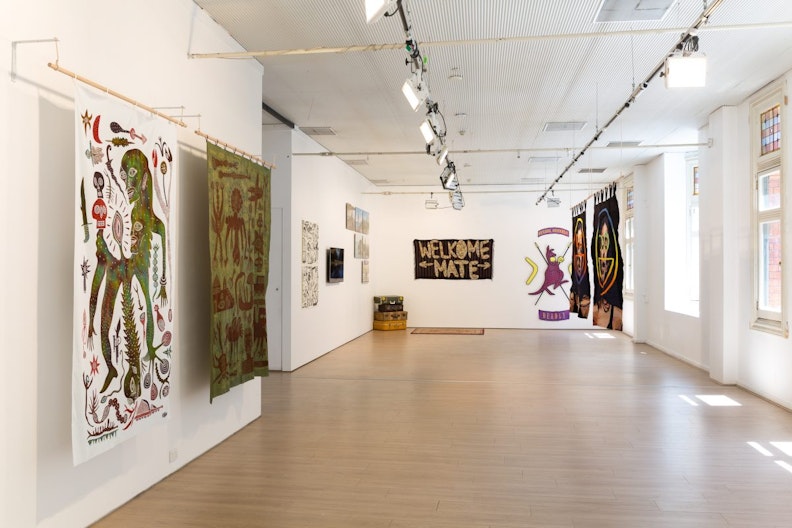 Jogja Calling (2016), first floor exhibition view, 4A Centre for Contemporary Art. Clockwise from right: Arwin Hidayat, Roh Roh Dalam Senjata (The Spirits Inside The Weapon), 2016; Reko Rennie, Warriors Come Out to Play, 2014; Uji Handoko Eko Saputro aka Hahan, Welkome Mate, 2012; Reko Rennie, Crest, 2014; Abdul Abdullah,Be happy, 2016; Abdul Abdullah, Don’t worry, 2016. Installation view. Courtesy the artists and Fehily Contemporary. Image: Document Photography.