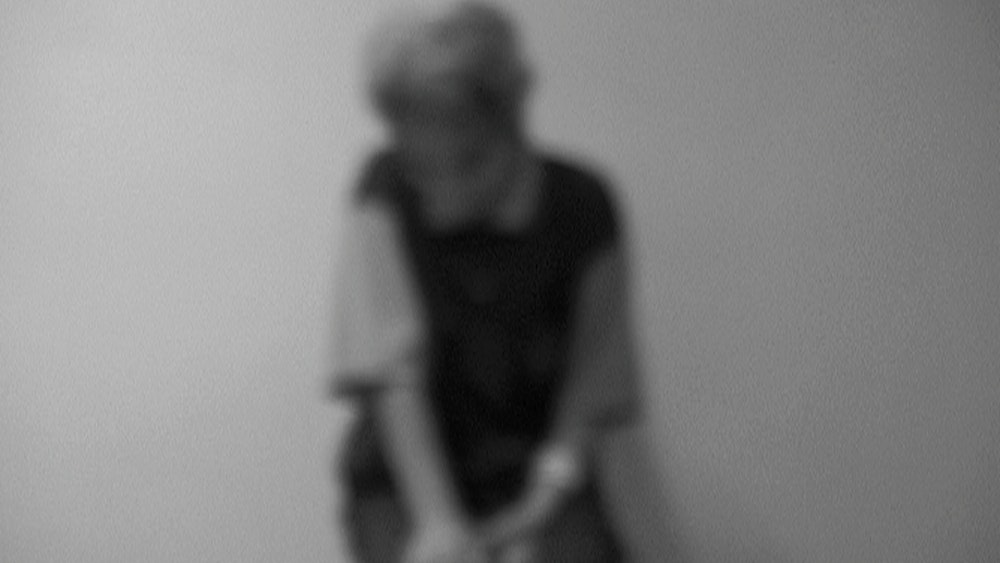 A blurry black and white photograph as part of Araya Rasdjarmrearnsook's exhibition Storytellers of the Town